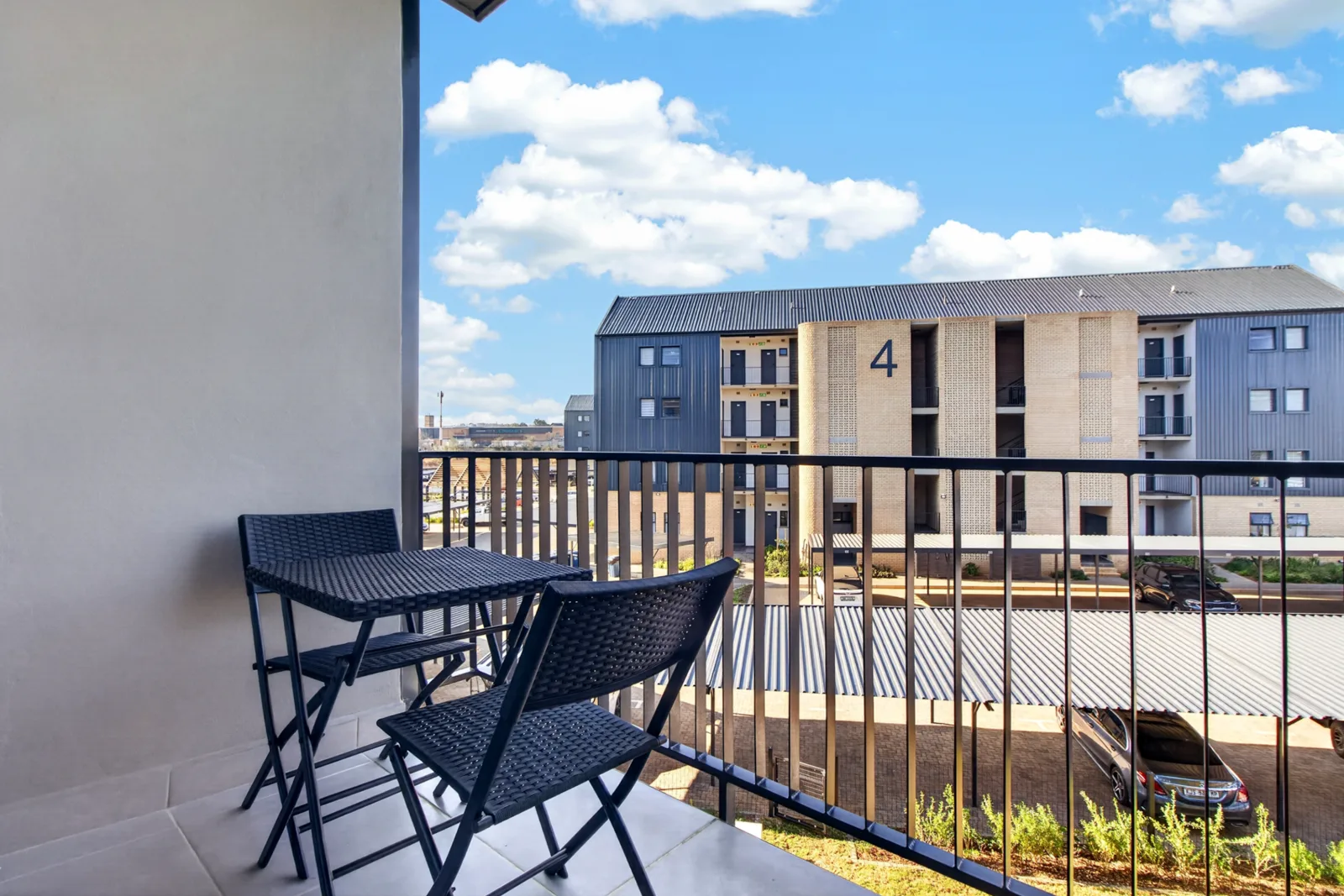 Balcony table and chairs with a view over the estate