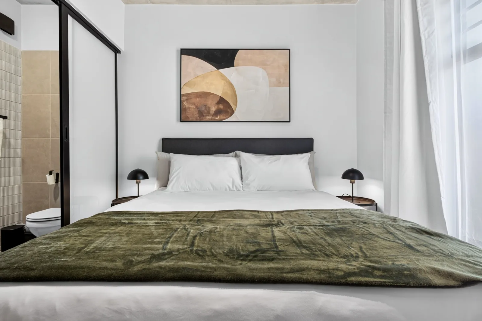 Main bedroom, queen bed beneath artwork